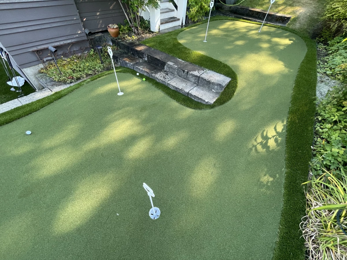 A fun artificial turf putting green with fringe installed overlooking the lake in Lakewood, WA.