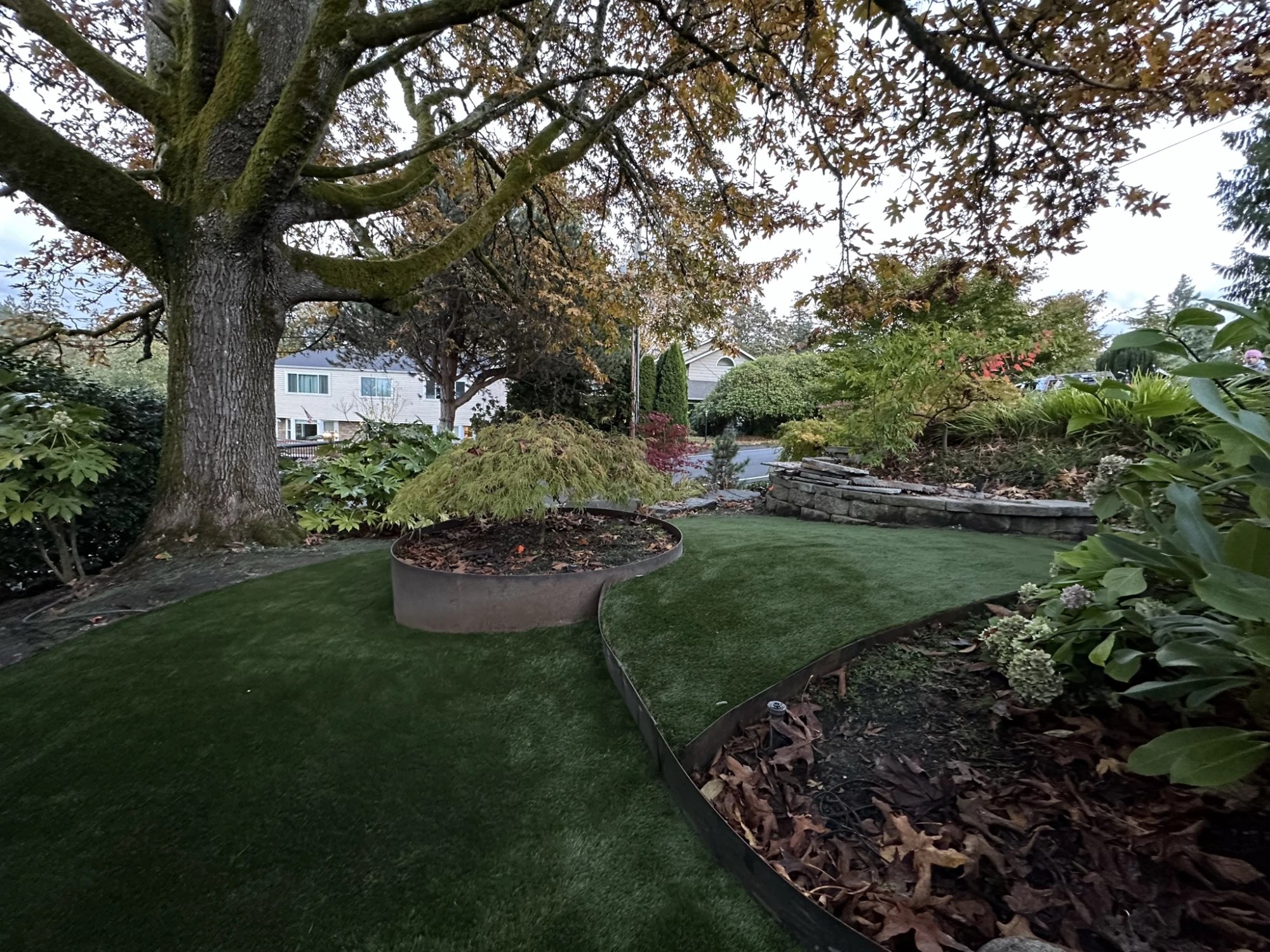 Corten steel edging with artificial grass installed.